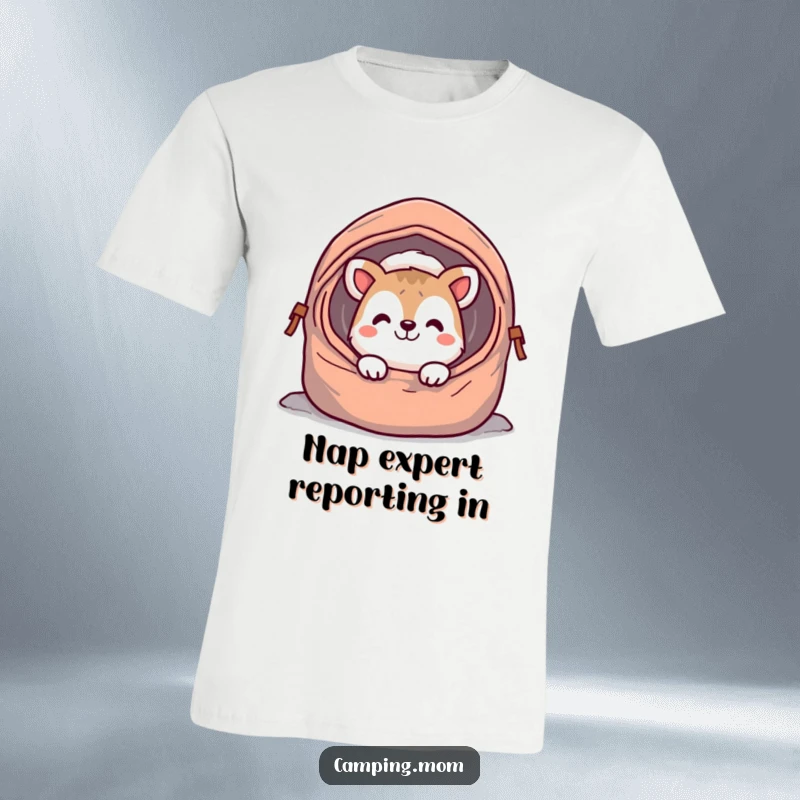 Funny camping animal t-shirt, peeking out from a sleeping bag with a wide, cheerful grin, embodying morning joy and humor.
